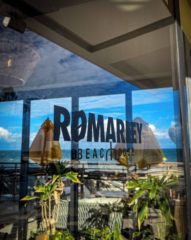 Beachfront seating and dining tables at RoMarley Beach House