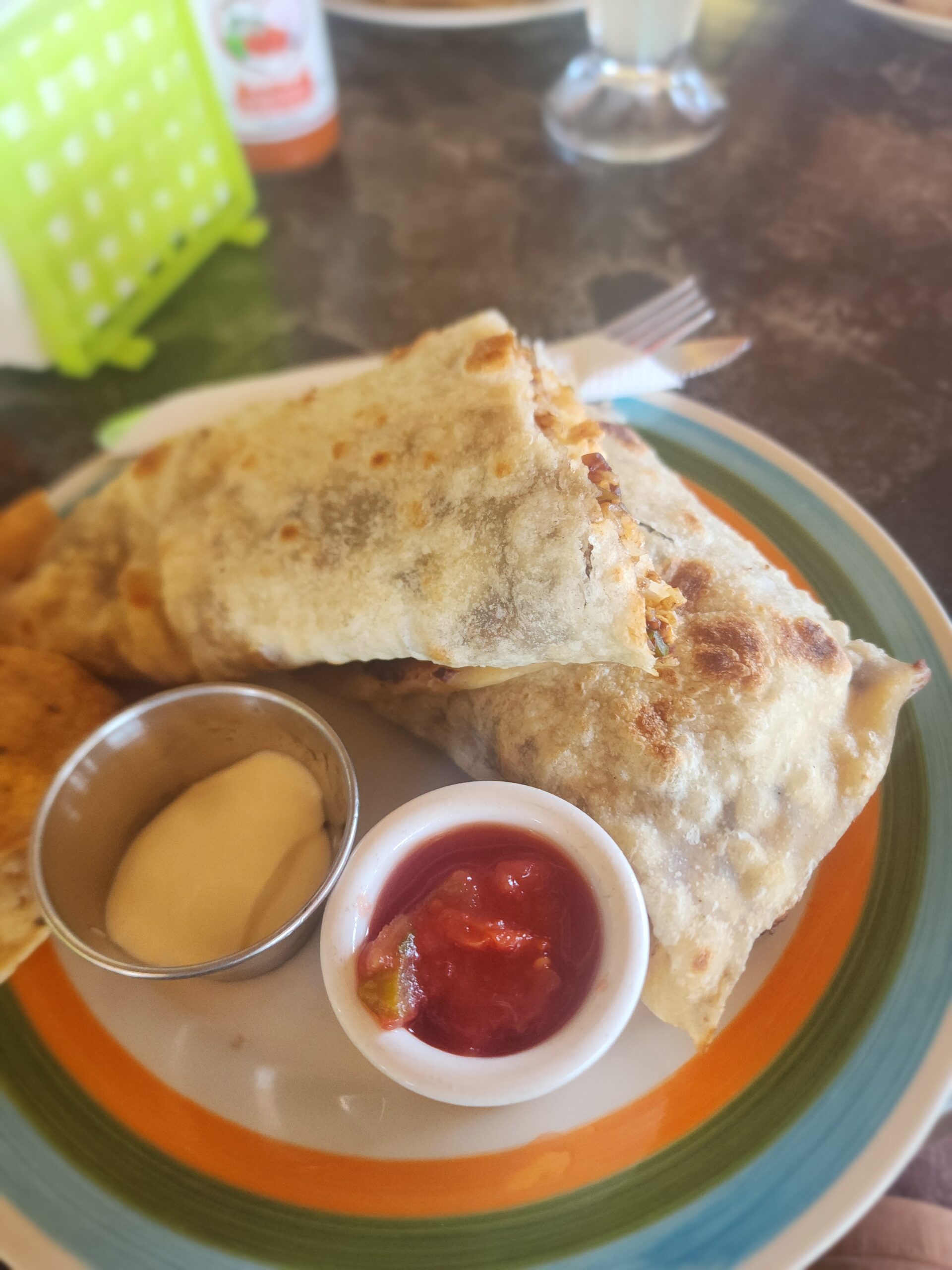 Palm-shaded beachfront seating at Maximo’s Bar & Grill